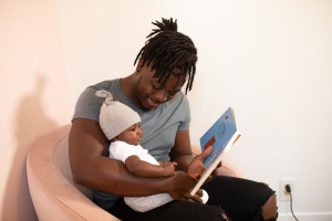 Dad reading to baby.